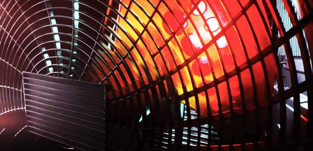 Close-up of heat pump fan and heating element in a commercial system.