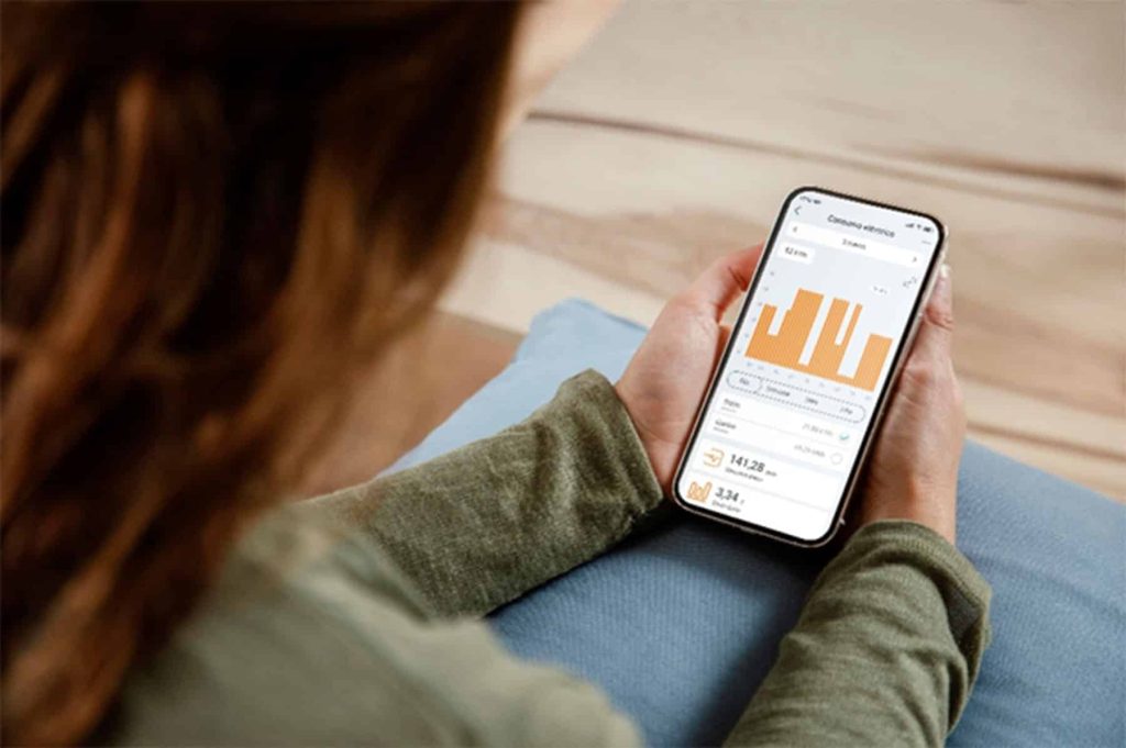 Energy management system on smartphone screen showing data and graphs.