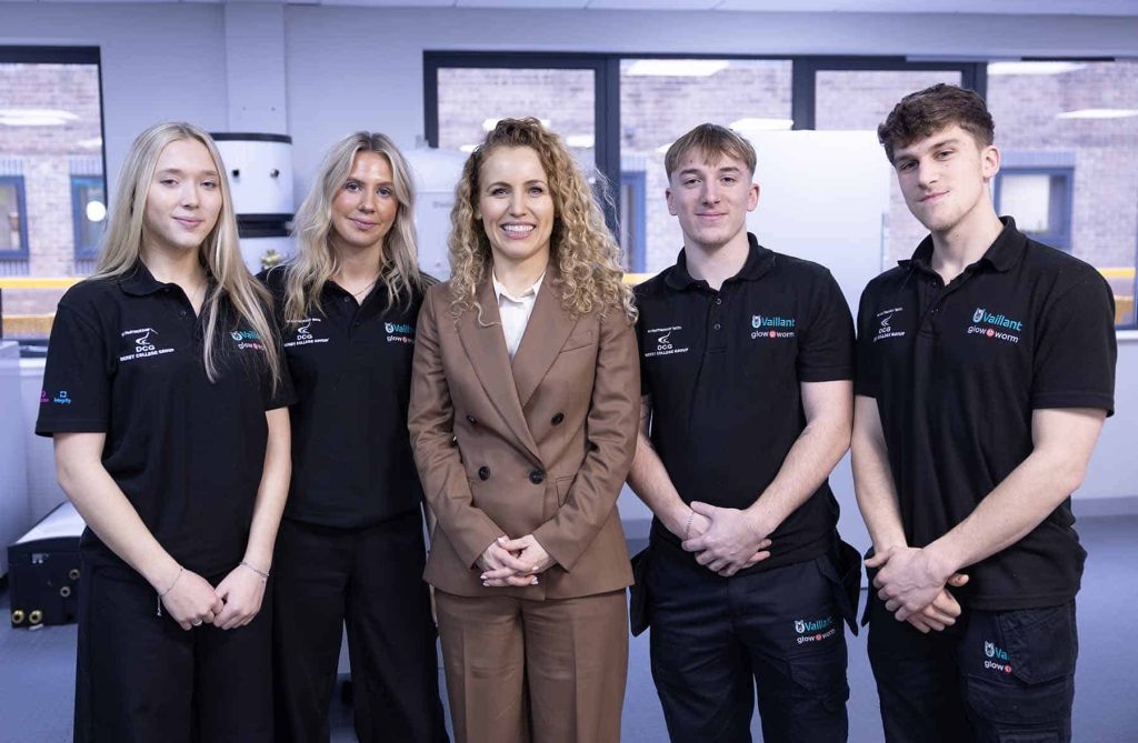 Minister with team at Vaillant event promoting heat pump technology.