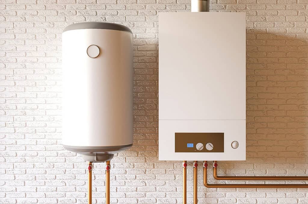 Heat pump and water heater system installed on a white brick wall for energy-efficient heating.