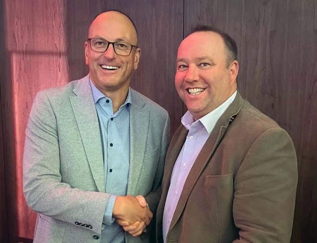 Business professionals shaking hands at a networking event.