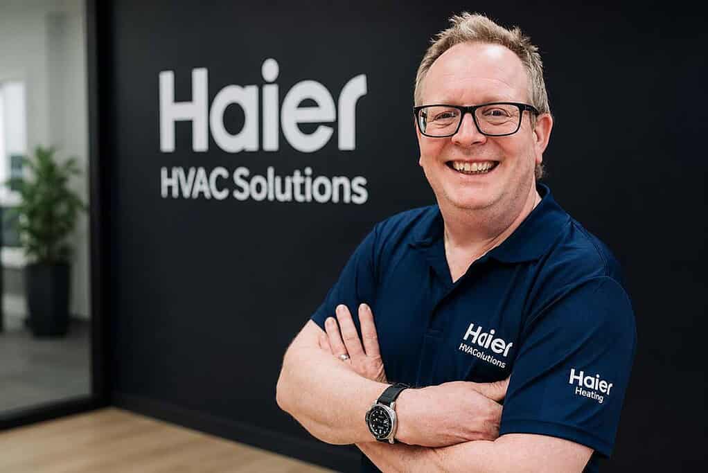 Smiling Haier HVAC Solutions representative in office.