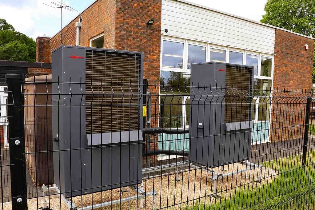Heat pump units installed outside a building for efficient heating and cooling.