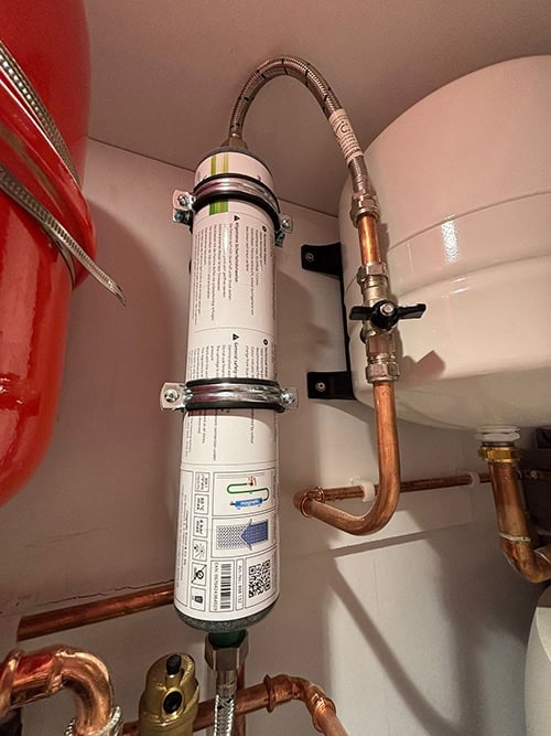 High-efficiency heat pump filter system with copper piping and plumbing components.