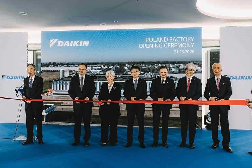 Group of executives at Daikin Poland factory opening, cutting ribbon, new facility launch.