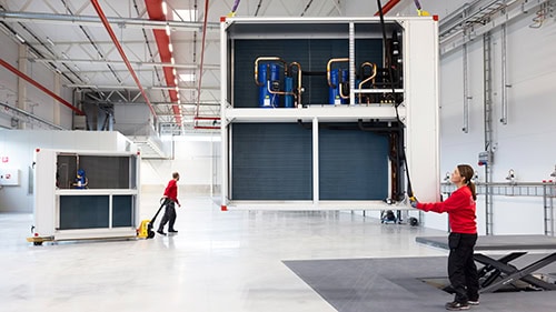 Large industrial heat pump with R290 and R454C refrigerants in a factory setting.