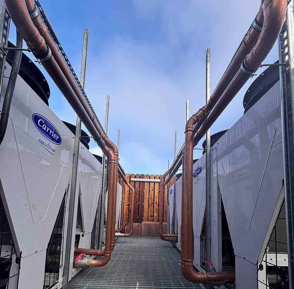 District heating heat pumps with copper piping at a college campus.