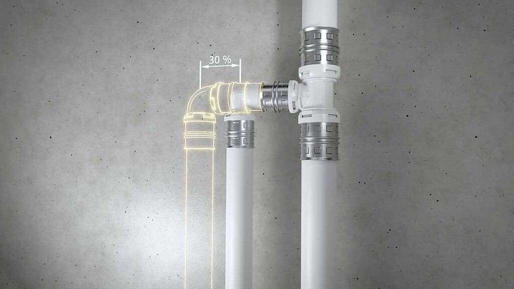 Close-up of heat pump piping with measurements and fittings.