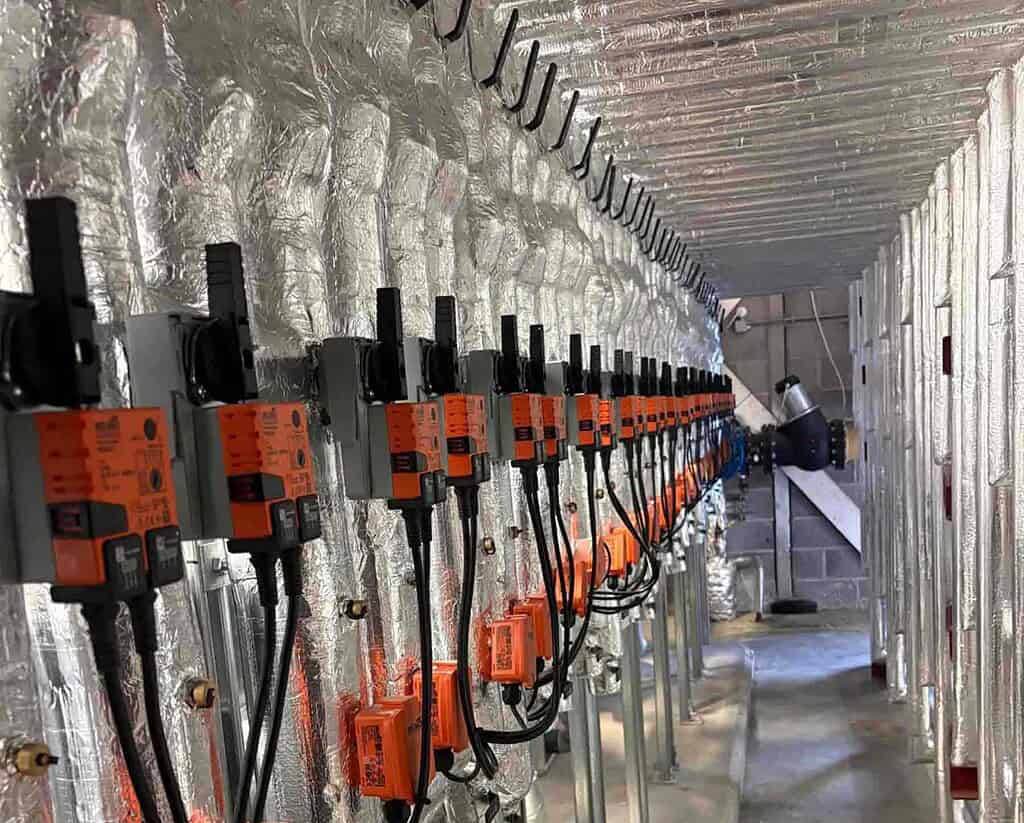 Industrial heat pump system with multiple control units in a building.