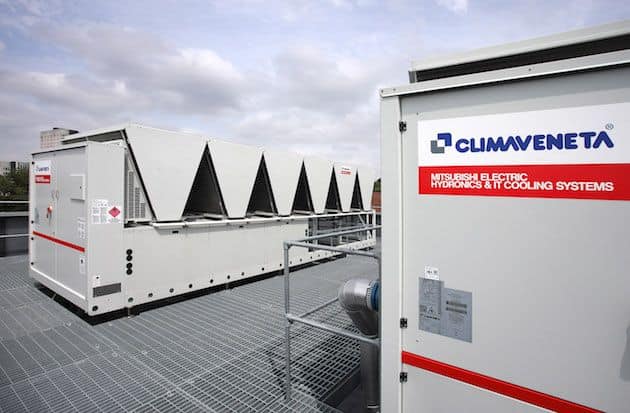 Large heat pump units installed on a rooftop for energy efficiency.