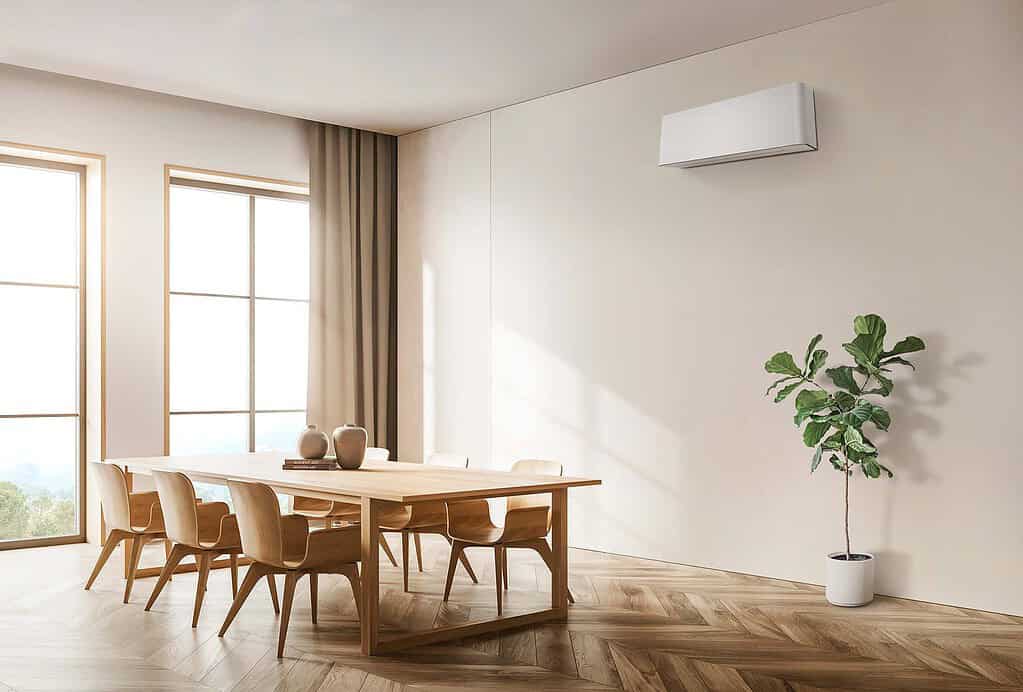 Modern room with wall-mounted air conditioner and dining table.