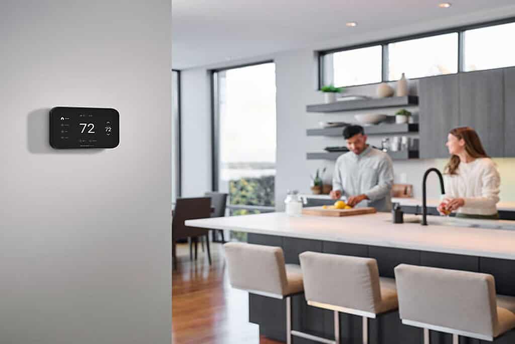 Modern smart thermostat control in a contemporary kitchen setting.