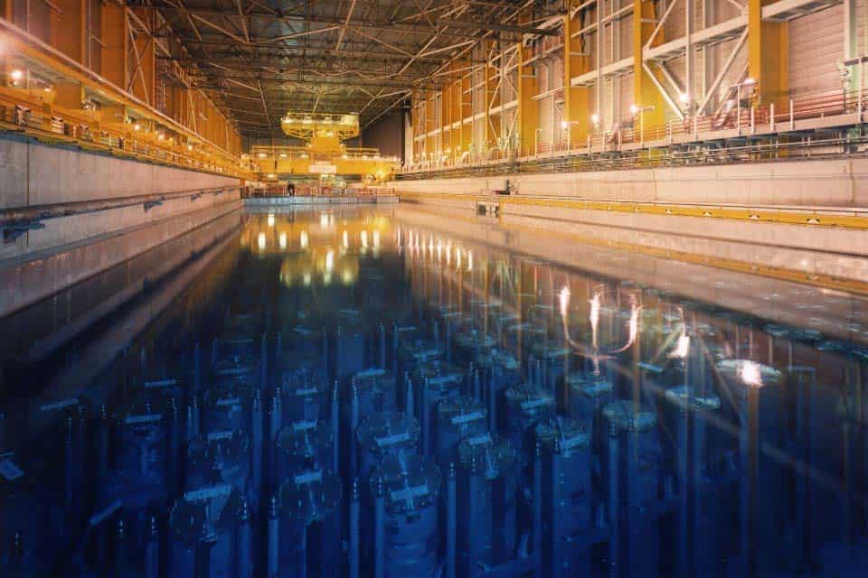 Industrial facility with large water pool and heavy machinery for heat recovery.