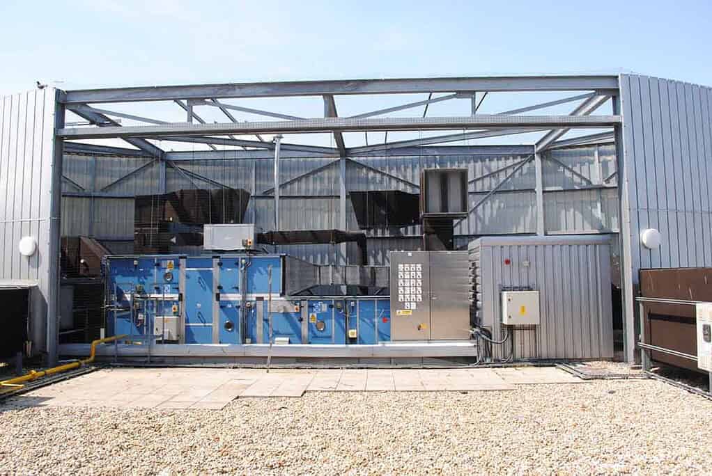 Industrial heat pump system with control panel and ductwork.