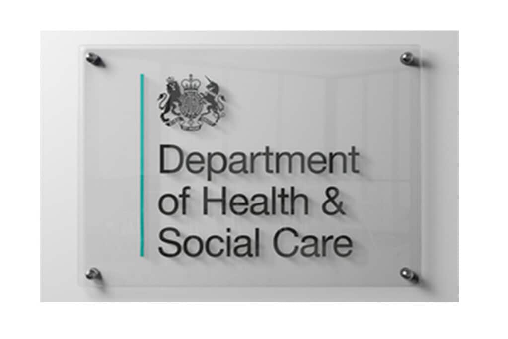 Official Department of Health & Social Care sign on glass.