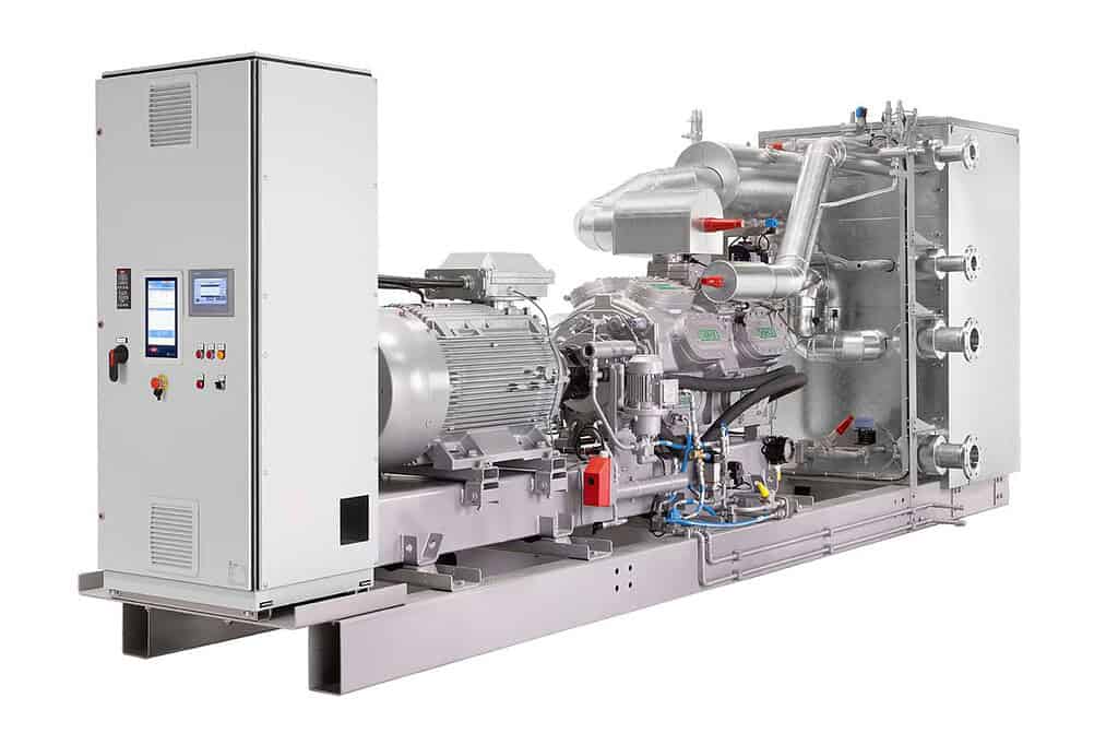 Large industrial heat pump system with control panel and piping.