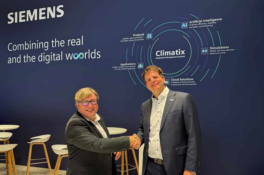 Two men shaking hands at Siemens Climatix digital solutions event.